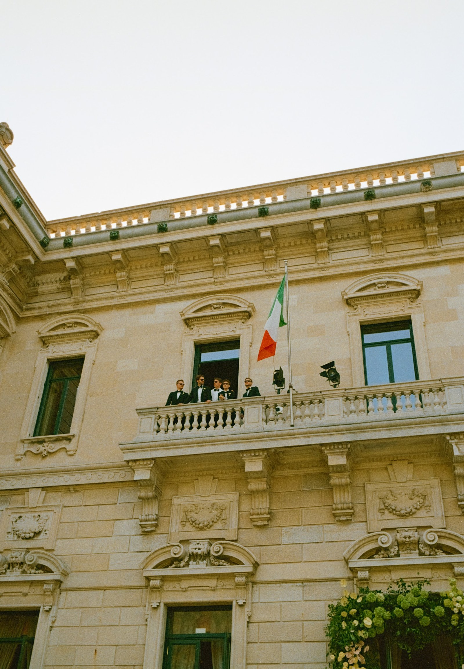 Villa Erba facade with people standing on the balcony