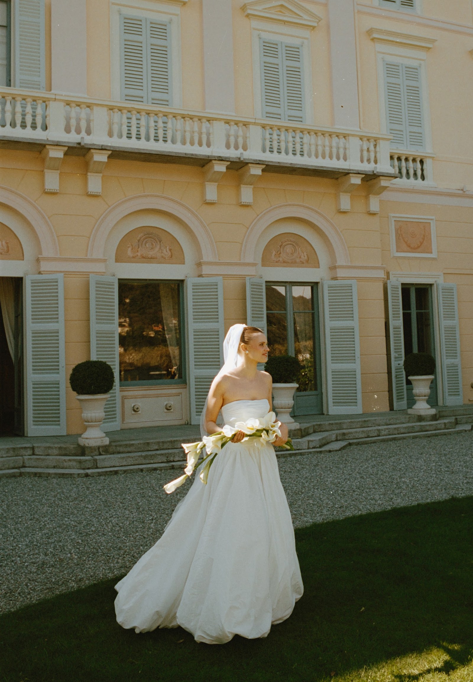 A person in a wedding dress outside Villa Revel Parravicini